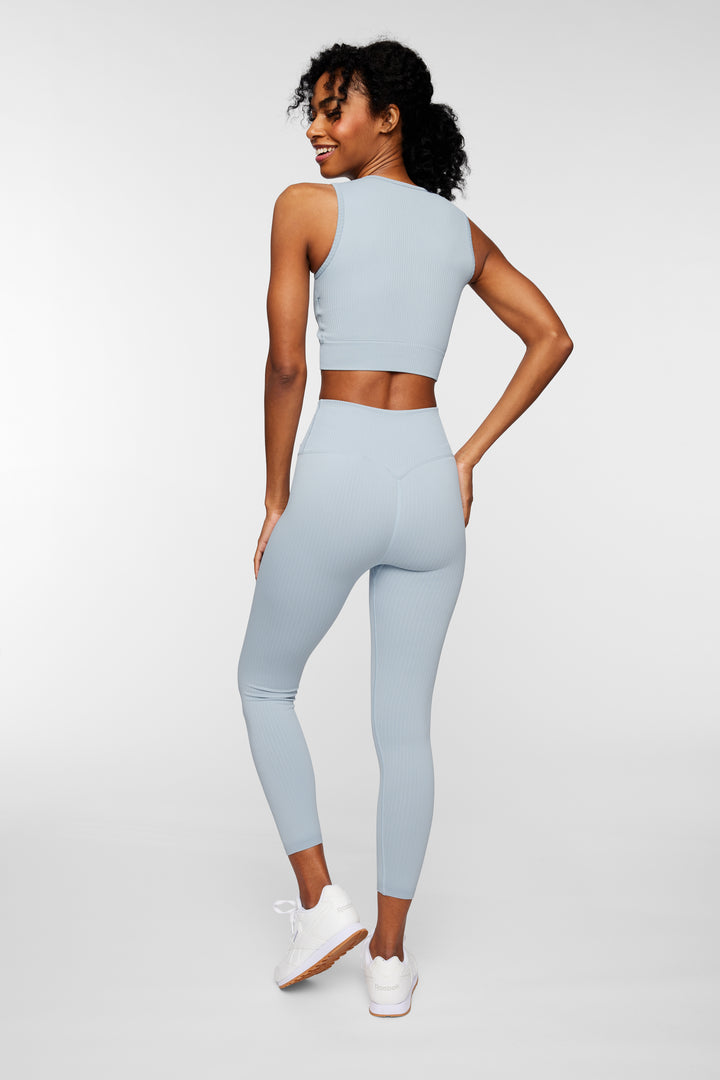 Back view of woman in aqua ribbed seamless leggings showing sculpted fit and support